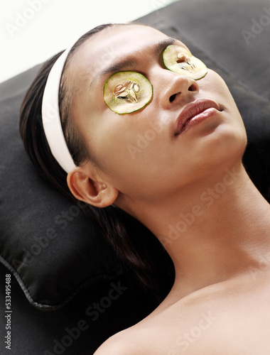 Woman receiving a facial at the outdoor relaxation pavilion at a resort spa. Bali, Indonesia photo