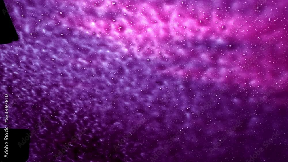 Cleaning foam on a car glass. Soapy window. Car wash service station. View from inside a cabin. Abstract background purple color. High pressure gun with shampoo. Flowing texture close-up. Abstraction. Cleaning foam on a car glass. Soapy window. Car wash service station. View from inside a cabin. Abstract background purple color. High pressure gun with shampoo. Flowing texture close-up. Abstraction.