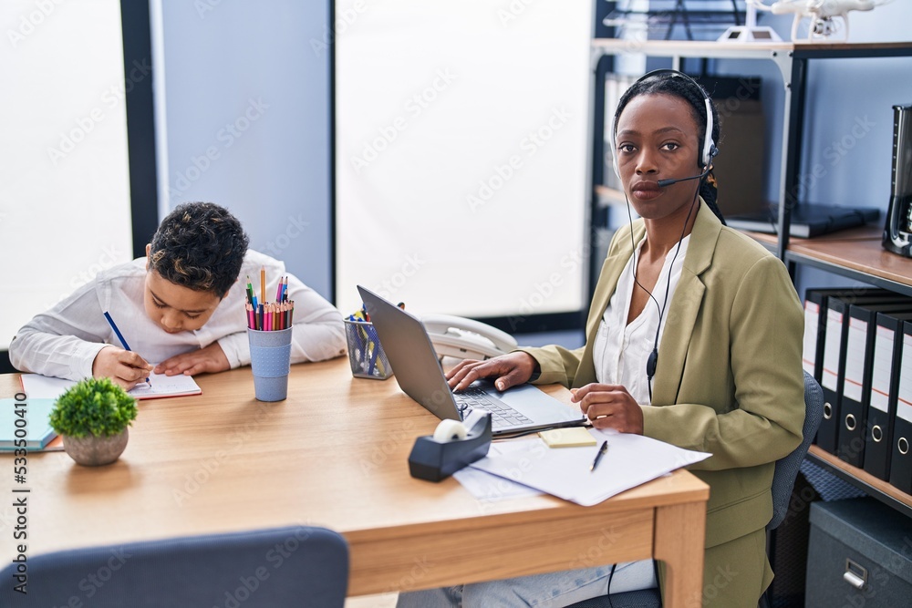 Young mother wearing call center agent headset thinking attitude and sober expression looking self confident Young mother wearing call center agent headset thinking attitude and sober expression looking self confident