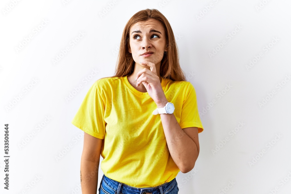Young brunette woman standing over isolated background thinking worried about a question, concerned and nervous with hand on chin Young brunette woman standing over isolated background thinking worried about a question, concerned and nervous with hand on chin