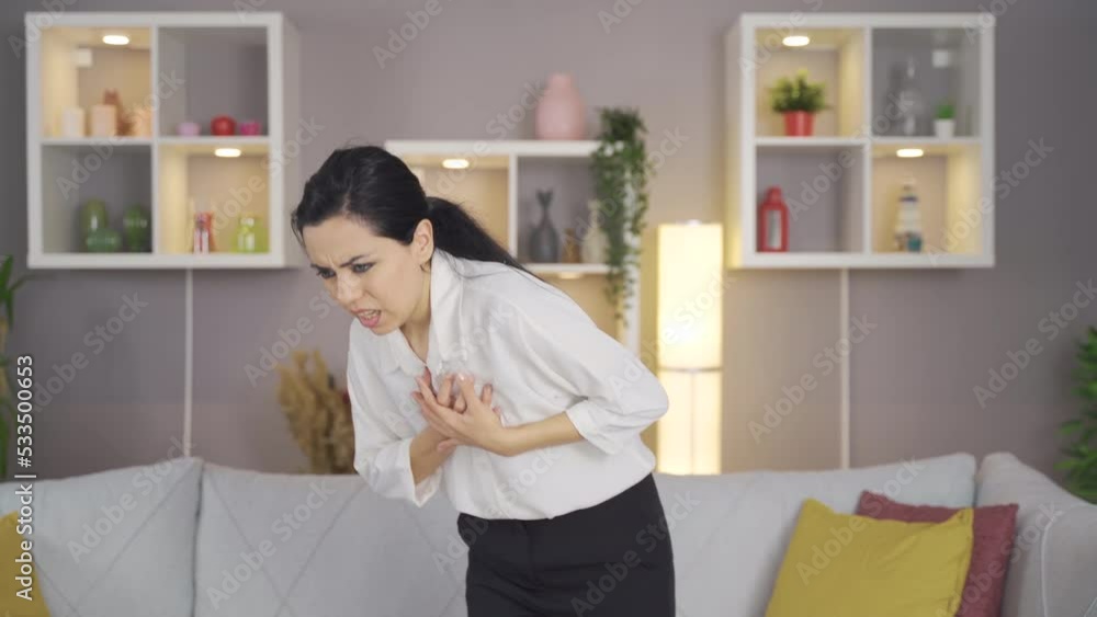 Woman having heart attack at home.
Young woman sitting at home and standing up and holding her heart back and expression of pain and fear on her face.
Woman having heart attack at home.
Young woman sitting at home and standing up and holding her heart back and expression of pain and fear on her face.