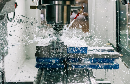 Photos Machinist using haas milling machining / CNC machining creating machine parts in