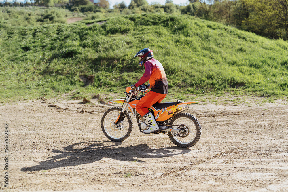 Obraz premium Extreme and Adrenaline. Motocross rider in action. Motocross sport. Active lifestyle.