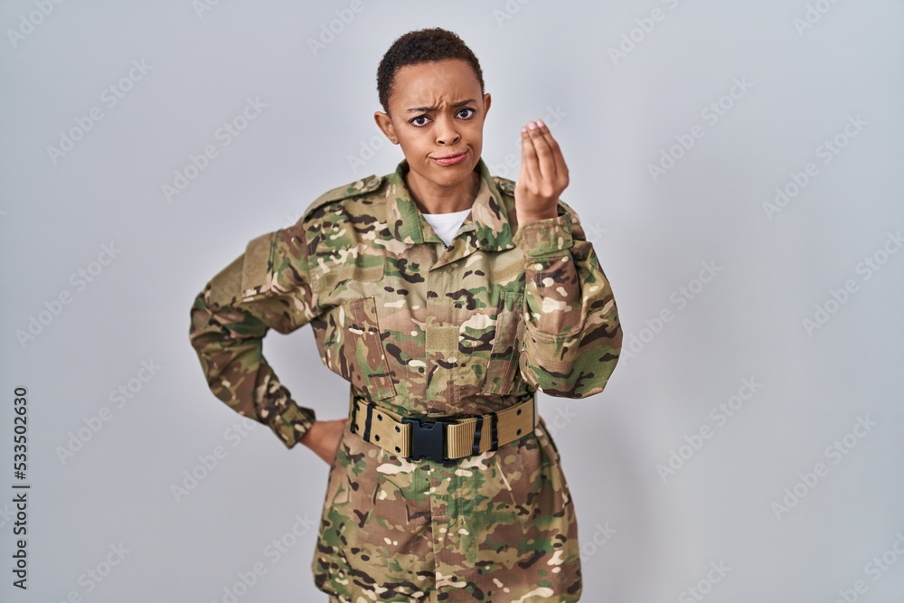 Beautiful african american woman wearing camouflage army uniform doing italian gesture with hand and fingers confident expression