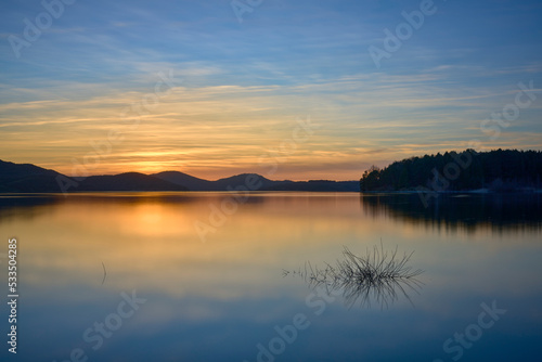 Golden sunset over lake and mountains © samey