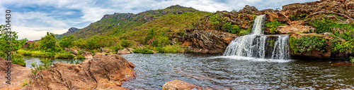 Waterfall and lakes with mountains in background on Biribiri environmental reserve on Diamantina, Minas Gerais state, Brazil.