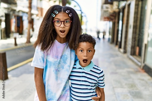 African american family of bother and sister standing at the street scared and amazed with open mouth for surprise, disbelief face