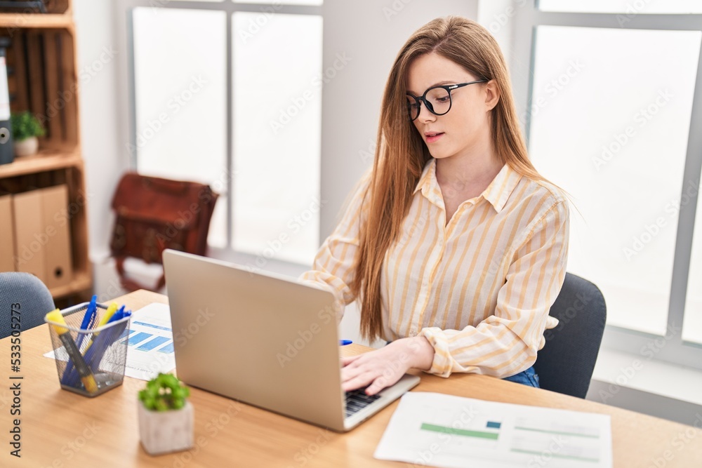 Young blonde woman business worker using laptop working at office Young blonde woman business worker using laptop working at office
