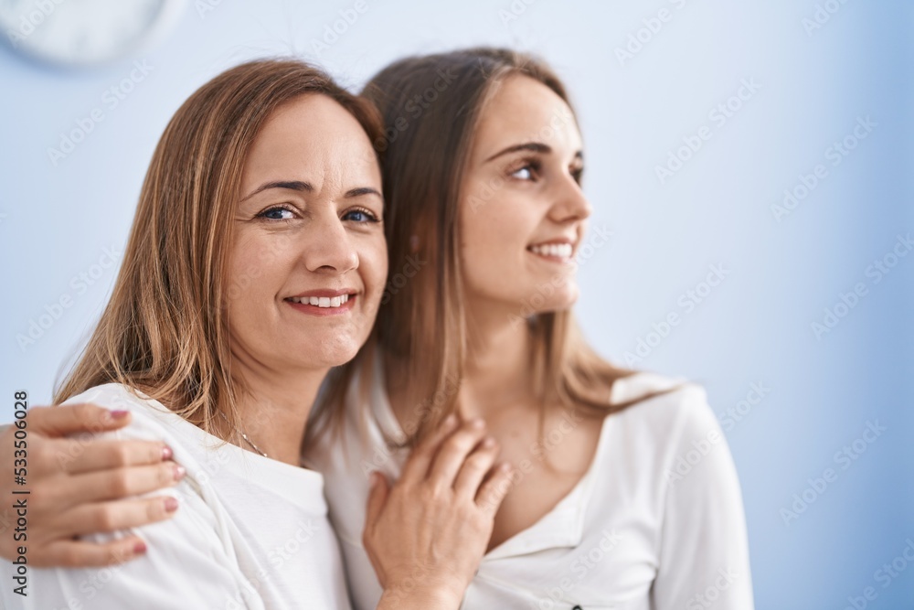 Two women mother and daughter hugging each other at home Two women mother and daughter hugging each other at home