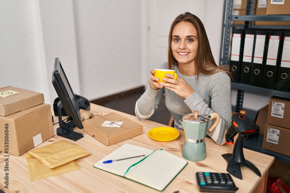 Young blonde woman ecommerce business worker drinking coffee at office Young blonde woman ecommerce business worker drinking coffee at office
