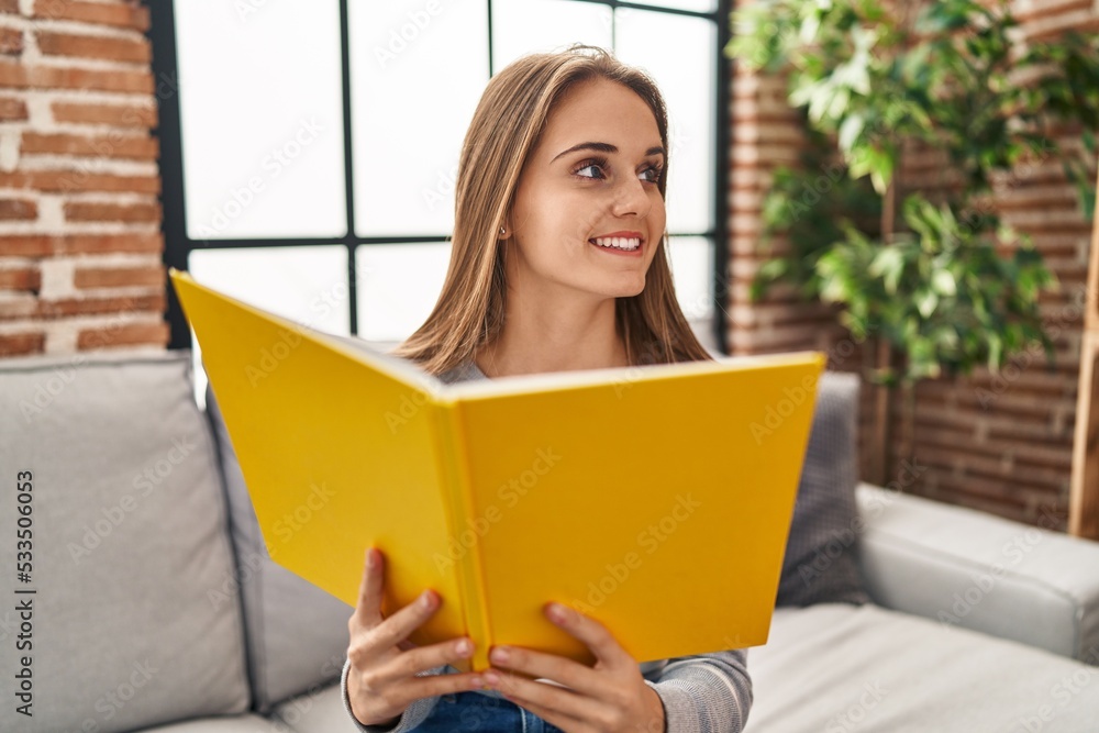 Young blonde woman smiling confident reading book at home Young blonde woman smiling confident reading book at home