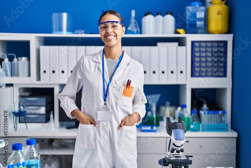 Young african american woman scientist smiling confident standing at laboratory