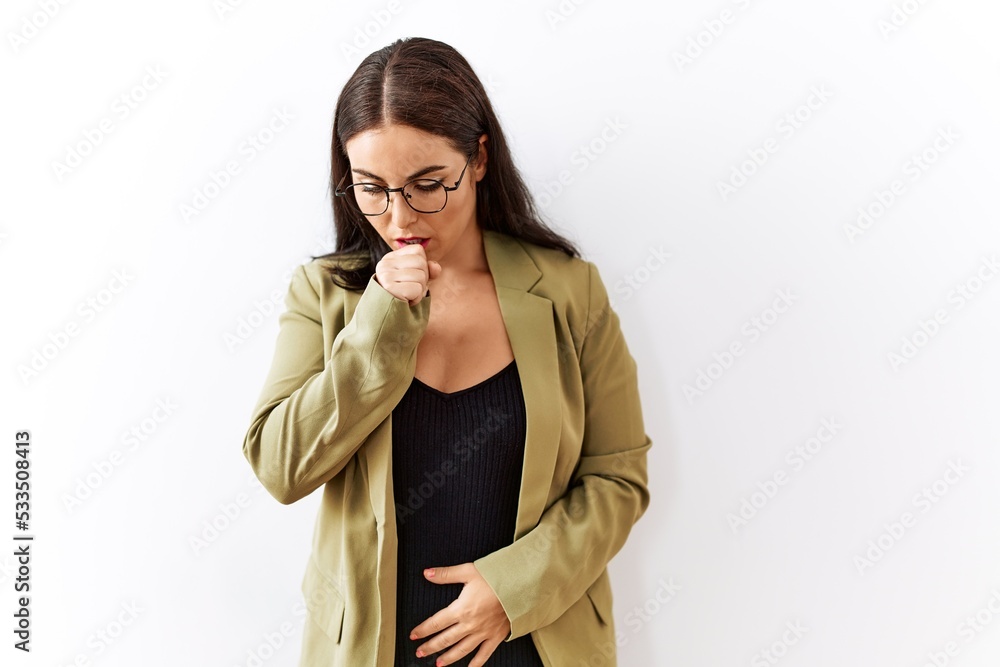 Young brunette woman standing over isolated background feeling unwell and coughing as symptom for cold or bronchitis. health care concept. Young brunette woman standing over isolated background feeling unwell and coughing as symptom for cold or bronchitis. health care concept.