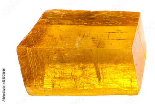 Foto Transparent yellow optical calcite Iceland spar stone on white surface