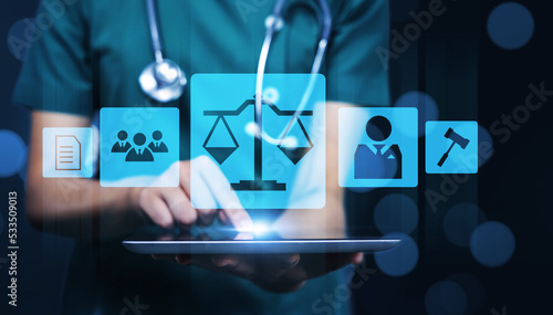 Medical healthcare pharmaceutical compliance law regulations and policies concept, female doctor holding tablet technology graphical showing law icon pharmacy healthcare contract rules human rights