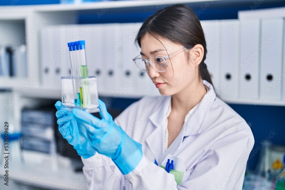 Chinese woman scientist holding test tubes at laboratory Chinese woman scientist holding test tubes at laboratory