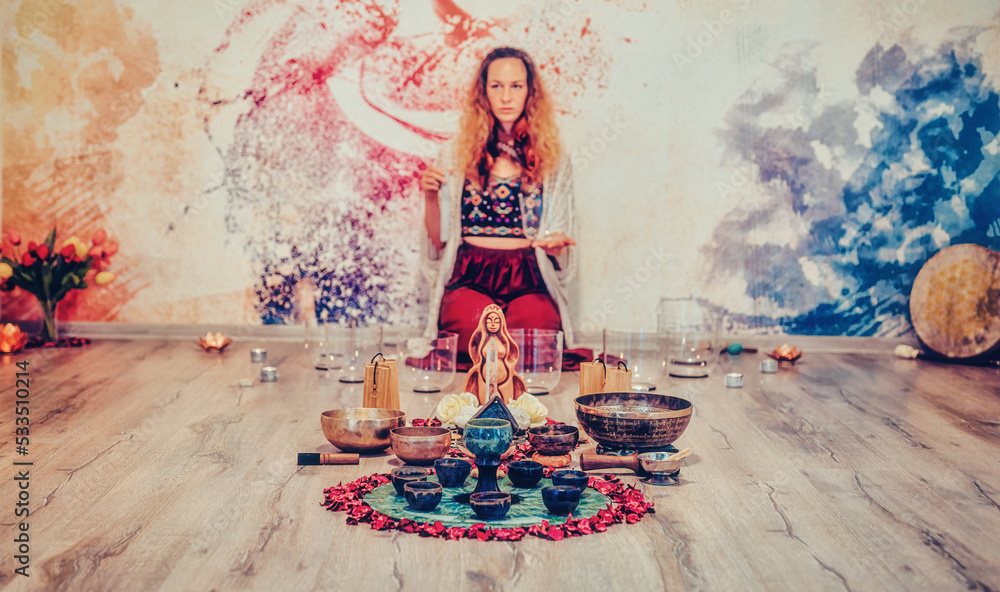 soundhealing, beautiful woman playing crystal bowls on cacao ceremony.