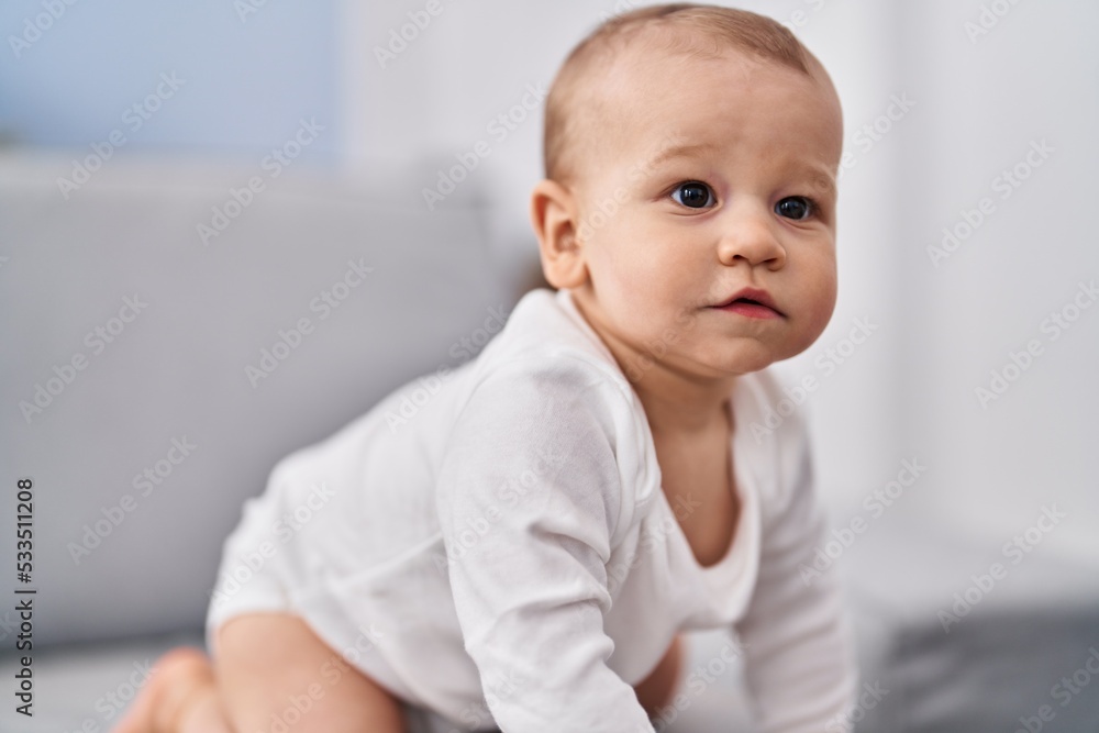 Adorable toddler crowling on sofa at home Adorable toddler crowling on sofa at home