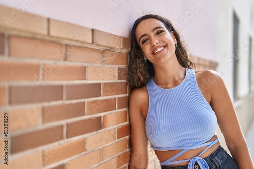 Young beautiful hispanic woman smiling confident standing at street © Krakenimages.com
