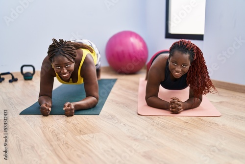 African american women smiling confident training abs exercise at sport center