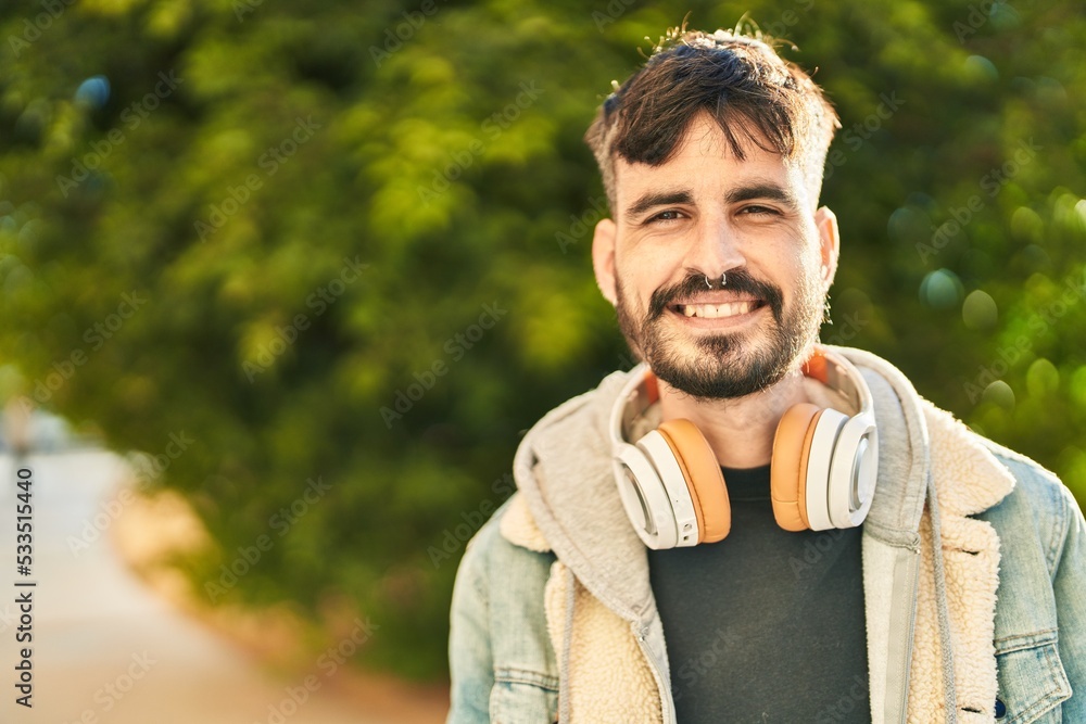 Young hispanic man smiling confident wearing headphones at park Young hispanic man smiling confident wearing headphones at park