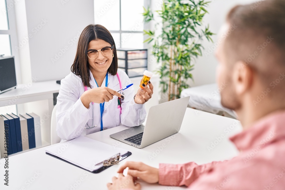 Man and woman doctor and patient having medical consultation prescribe pills at clinic Man and woman doctor and patient having medical consultation prescribe pills at clinic