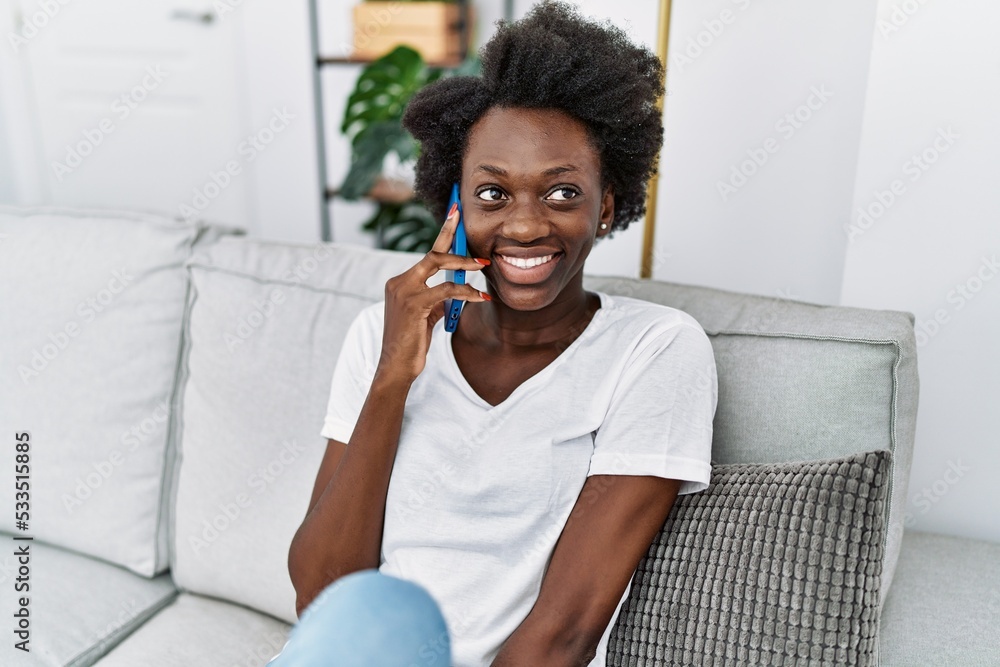 Young african american woman smiling confident speaking on the phone at home Young african american woman smiling confident speaking on the phone at home