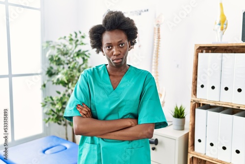 African young physiotherapist woman working at pain recovery clinic depressed and worry for distress, crying angry and afraid. sad expression.