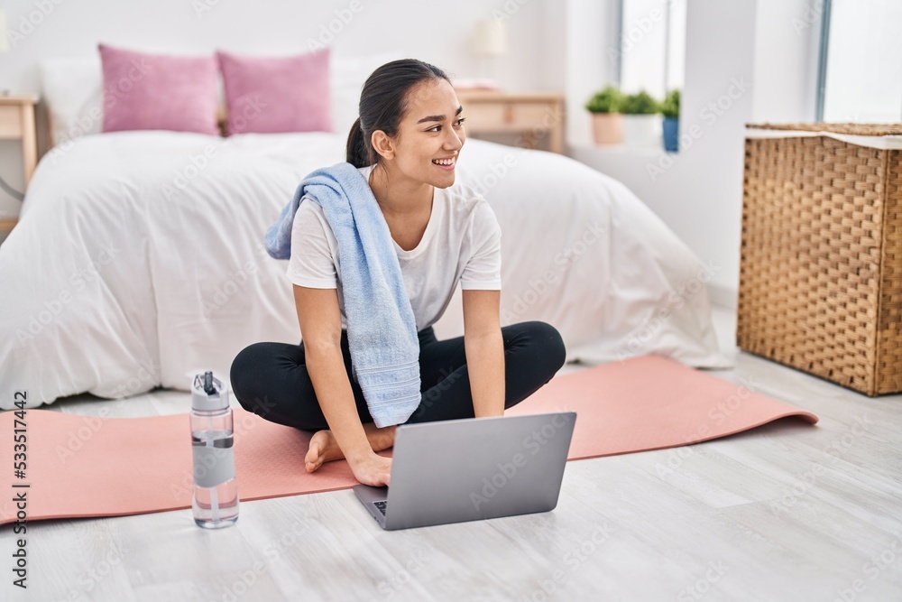 Young hispanic woman using laptop sitting on floor at bedroom Young hispanic woman using laptop sitting on floor at bedroom