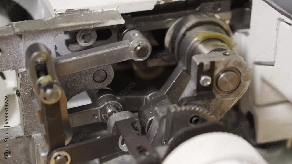 Mechanism of sewing equipment. Close-up. Repair of overlock and sewing machines. Mechanism at work Mechanism of sewing equipment. Close-up. Repair of overlock and sewing machines. Mechanism at work
