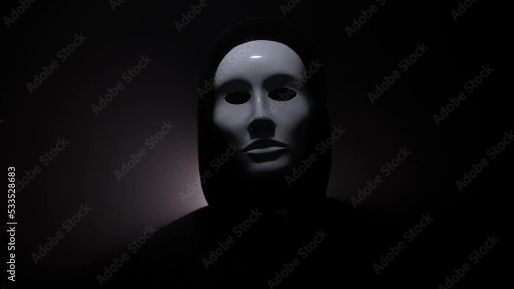 Man wearing mask with hoodie on black background. Man wearing mask with hoodie on black background.