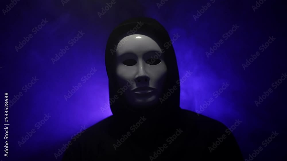 Man wearing mask with hoodie on blue background. Man wearing mask with hoodie on blue background.