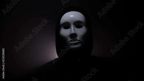 Man wearing mask with hoodie on black background. photo