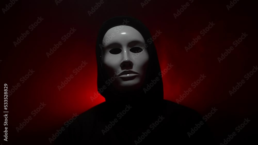 Man wearing mask with hoodie on red background. Man wearing mask with hoodie on red background.