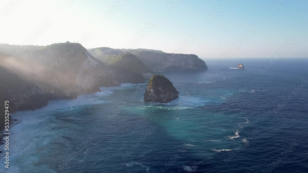 Aerial drone bird eye shot of rocky beach with cliff. Indian ocean shore. Nature and travel at day time. Beautiful natural summer vacation travel concept. Fly forward Aerial drone bird eye shot of rocky beach with cliff. Indian ocean shore. Nature and travel at day time. Beautiful natural summer vacation travel concept. Fly forward