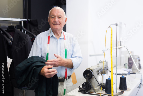 Portrait of an accomplished elderly tailor at his workplace in a sewing workshop