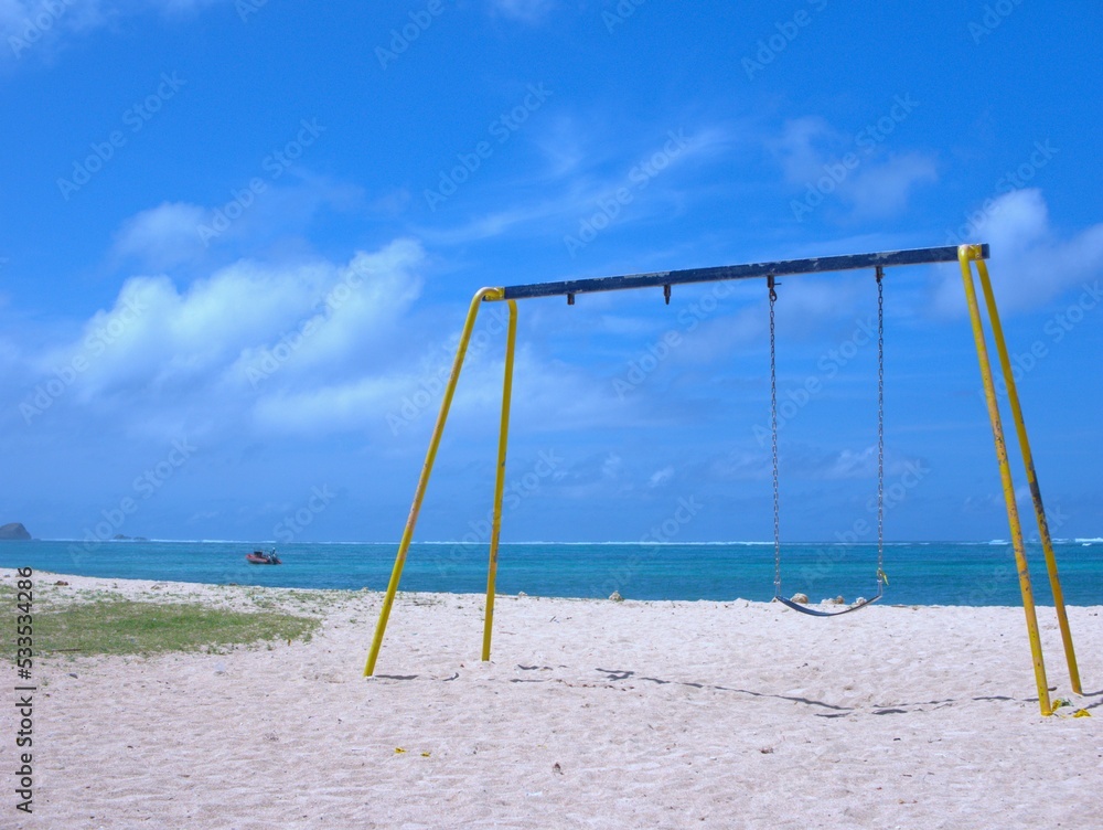 Children Swing in Kuta Mandalika Beach Children Swing in Kuta Mandalika Beach