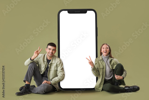 Young couple sitting near b...