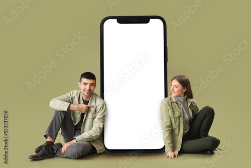 Young couple sitting near b...