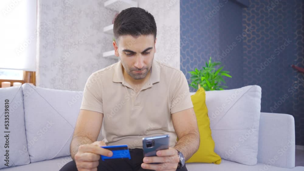 Shopping with a credit card.
Man shopping on his phone looking at his credit card.
Shopping with a credit card.
Man shopping on his phone looking at his credit card.