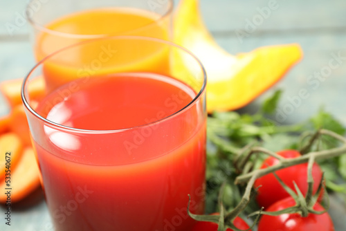 Delicious vegetable juice and fresh ingredients on table, closeup
