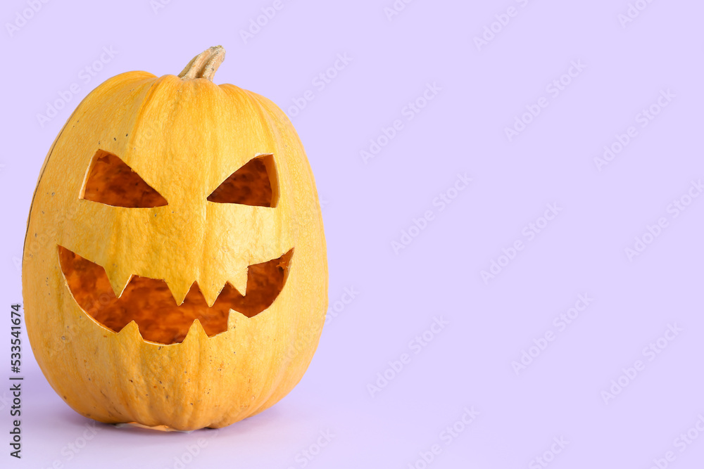 Fototapeta premium Jack-O-Lantern pumpkin on lilac background