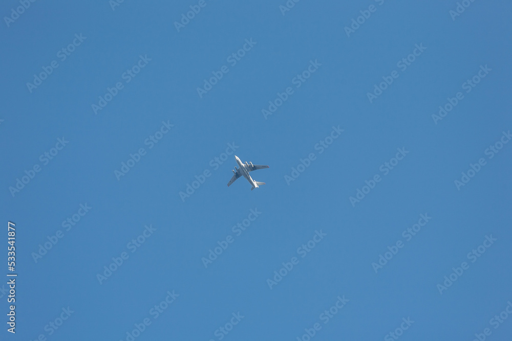 Flying passenger plane high against the blue sky Flying passenger plane high against the blue sky