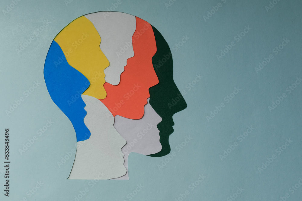 paper cut style Colored silhouette faces in head. Metaphor bipolar disorder,  Parkinson, Double face, Split personality, Psychology, Dual personality Mental health concept. Copy space. - obrazy, fototapety, plakaty 
