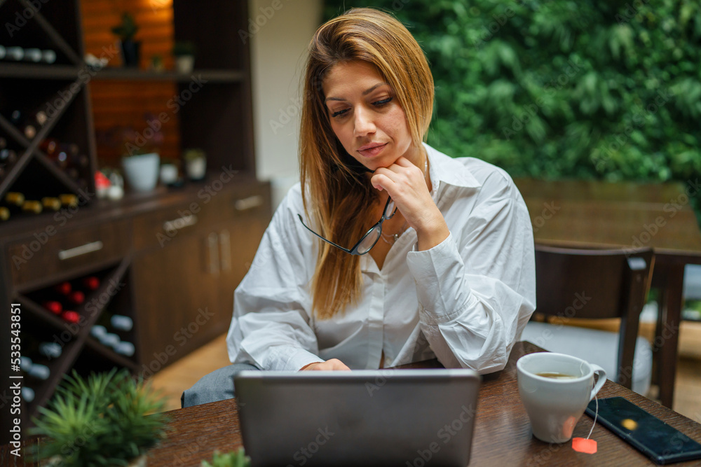 One female caucasian business woman with long hair and working on computer laptop Manager entrepreneur modern working concept One female caucasian business woman with long hair and working on computer laptop Manager entrepreneur modern working concept