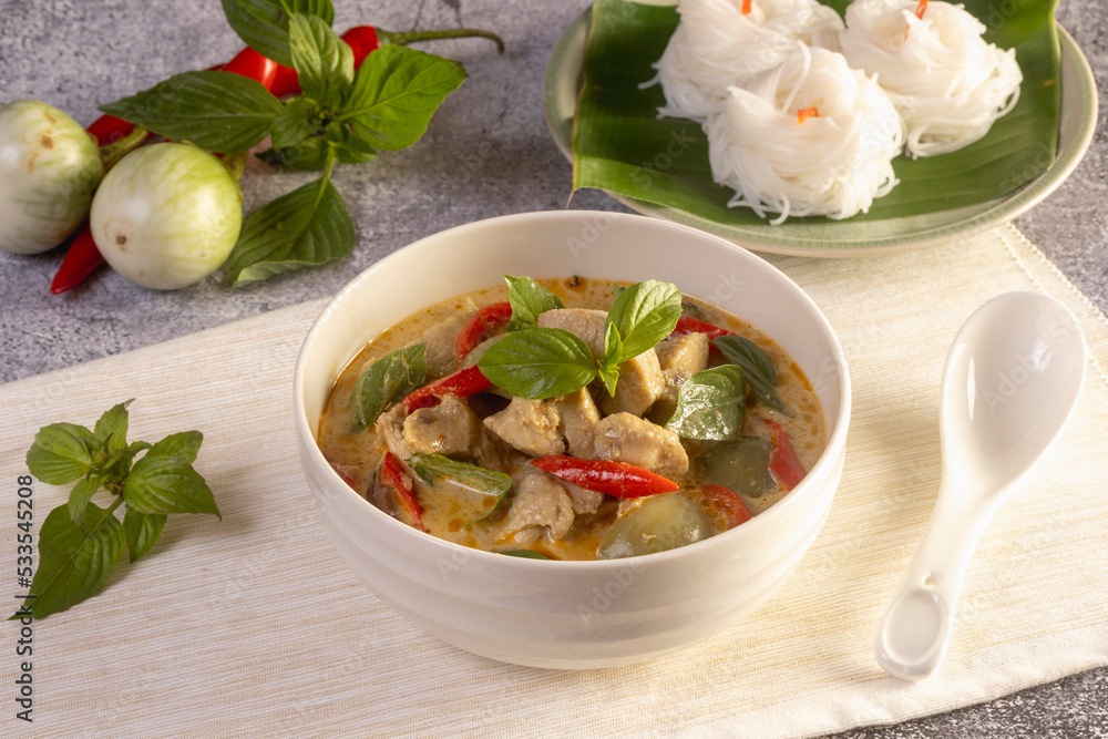 Thai food, green curry chicken with coconut curry on a wooden table. Thai food, green curry chicken with coconut curry on a wooden table.
