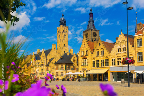 Market Square of Belgian city of Diksmuide with Gothic Town Hall and St Nicholas Church at summer day