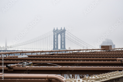 Manhattan Bridge is seen in a distance on a foggy day, March 17, 2022 in New York City.