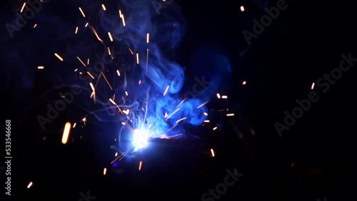 Welder man at factory working Spark welding of iron construction