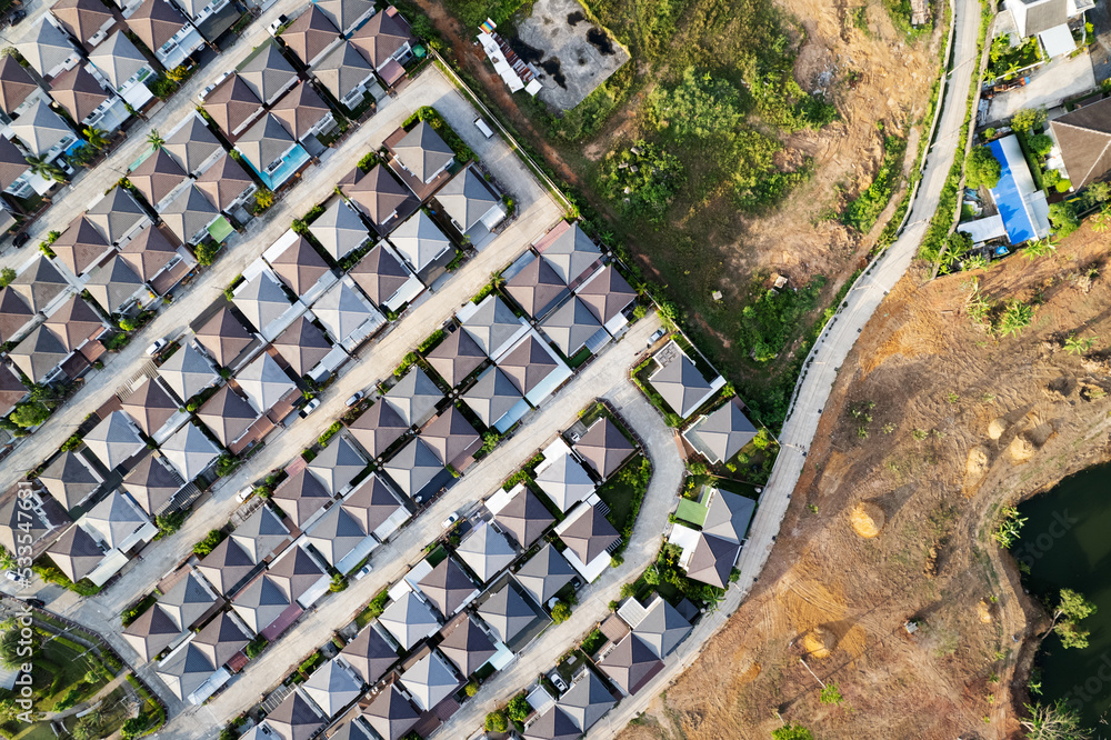 New development real estate. Aerial view of residential houses and driveways neighborhood during a fall sunset or sunrise time.Tightly packed homes.Top down view over private houses in phuket thailand New development real estate. Aerial view of residential houses and driveways neighborhood during a fall sunset or sunrise time.Tightly packed homes.Top down view over private houses in phuket thailand